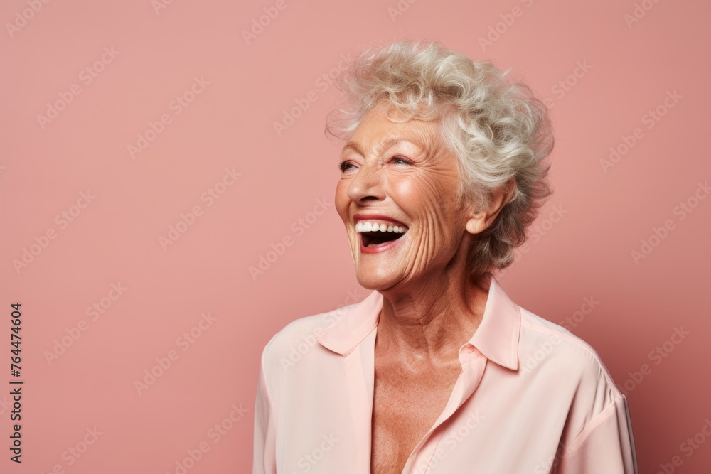 Portrait of a smiling senior woman. Isolated over pink background. Portrait of a smiling senior woman. Isolated over pink background.