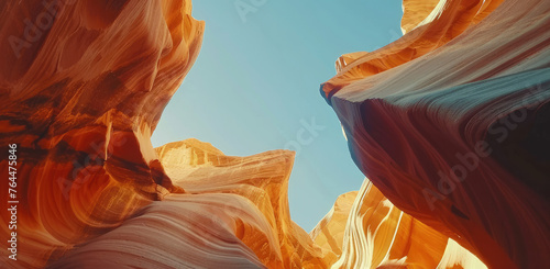 anamorphic shot of antelope canyon, rock formations in the shape of waves and hearts, warm colors, blue sky