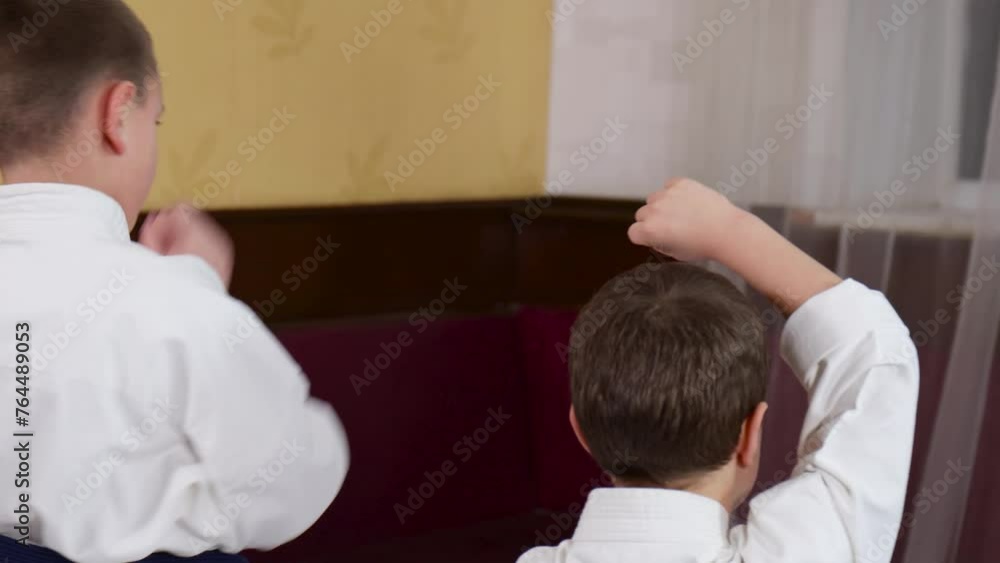 Coach and athletes train a block against a punch to the head Coach and athletes train a block against a punch to the head