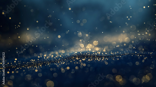 Blurry gold glitter on blue background