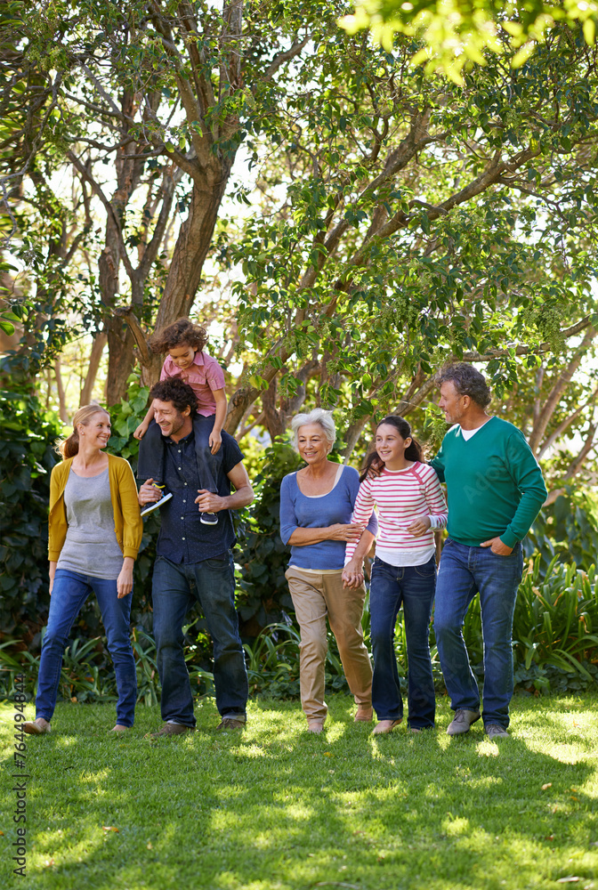 Happy family, conversation and together in outdoor nature, love and bonding or relax in backyard. Generations, smile and peace or communication for support in garden or park, vacation and holiday