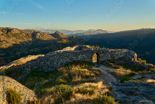 Medieval Castle Ruins of Castro Laboreiro high on a cliff in the mountains of northern Portugal inside Geras national park. photo