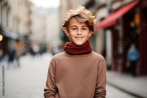 portrait of smiling teenage boy in autumnal coat on city street
