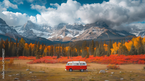 retro van parked on a grassy field, surrounded by a forest with vibrant orange and yellow leaves, and majestic snow-capped mountains in the background under a partly cloudy sky