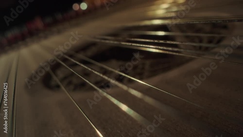 grand piano strings, no camera movement, closeup, slow motion, dark, yellow wood photo