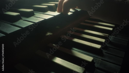 grand piano keyboard, camera moves forwards to the right, closeup, slow motion, dark, black photo