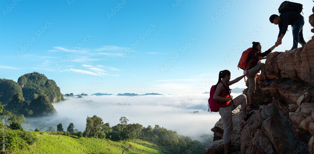 Asian hiking help each other on mountains - obrazy, fototapety, plakaty 