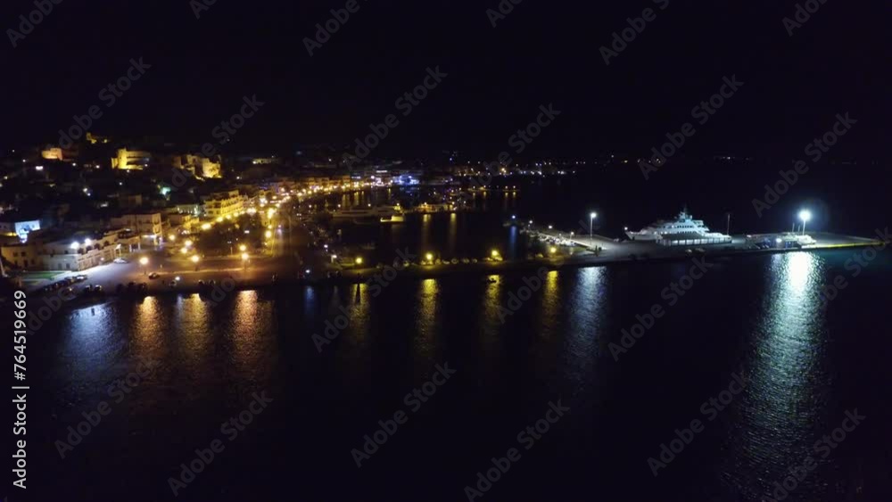 Aerial Forward Shot Of Cruise Ship Moored In Rippled Sea At Harbor At Night - Balkans, Greece Aerial Forward Shot Of Cruise Ship Moored In Rippled Sea At Harbor At Night - Balkans, Greece