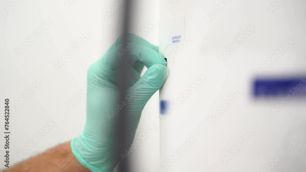 Radiologist's hand in glove works with x-ray machine in modern dental ...