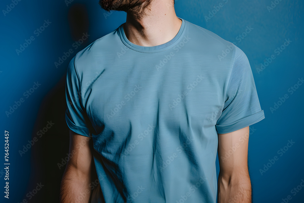 Mock up a man wearing a blue T-shirt posing confidently against a matching blue background, creating a minimalist and stylish aesthetic Mock up a man wearing a blue T-shirt posing confidently against a matching blue background, creating a minimalist and stylish aesthetic