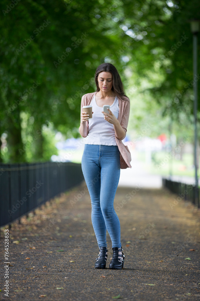 Caucasian college student using her smartphone. Caucasian college student using her smartphone.