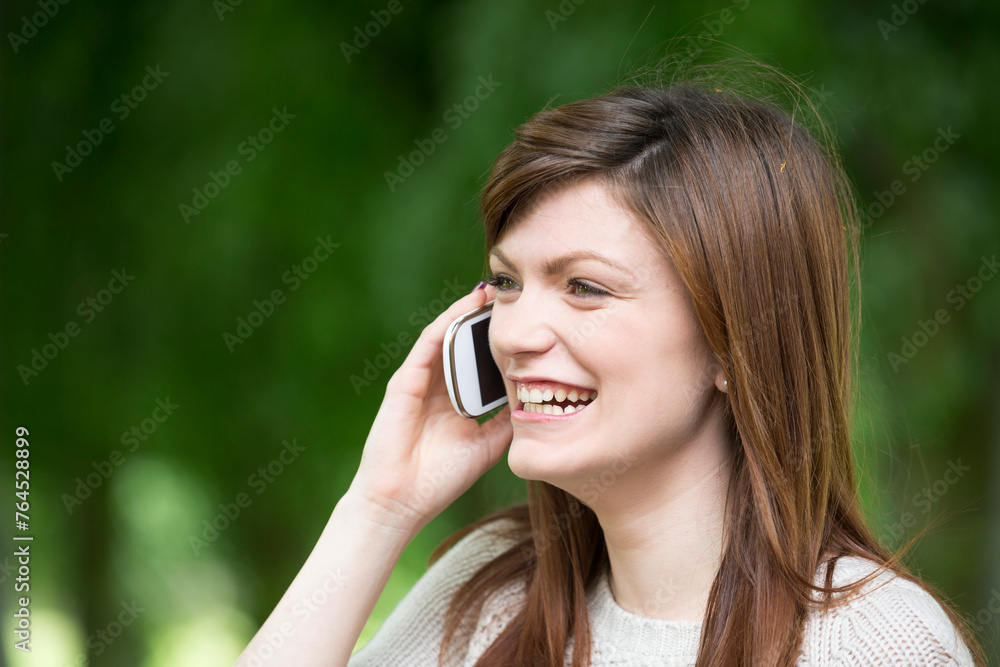 Caucasian college student using her smartphone. Caucasian college student using her smartphone.