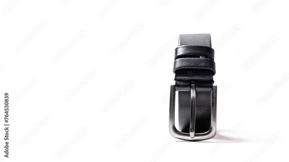 Twisted black leather belt with matted metal buckle isolated on white background. Fastened fashionable unisex, man or woman accessory for trousers, jeans, dress. Male luxury strap. Haberdashery goods Twisted black leather belt with matted metal buckle isolated on white background. Fastened fashionable unisex, man or woman accessory for trousers, jeans, dress. Male luxury strap. Haberdashery goods