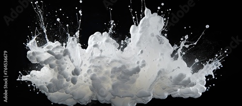 A high-speed photograph capturing the moment of a milk splash on a black background