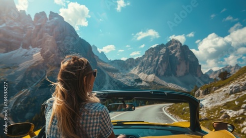 Woman driving yellow convertible on scenic mountain road, perfect for travel blogs or car advertisements