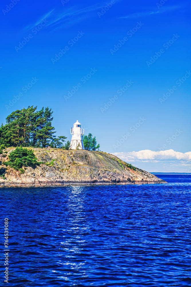 Rocky islet with a lighthouse in an archipelago