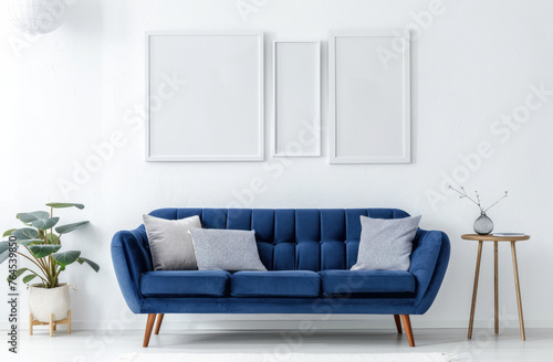 A modern living room with white walls, a blue armchair and sofa, a wooden coffee table, hanging pendant lights, decorative paintings on the wall