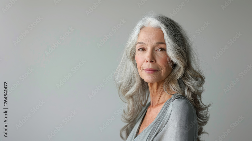 Fototapeta premium beautiful smiling elderly woman with gray hair on white background, lady, grandmother, old age, wrinkles, person, portrait, face, wrinkles, studio photo, skin care