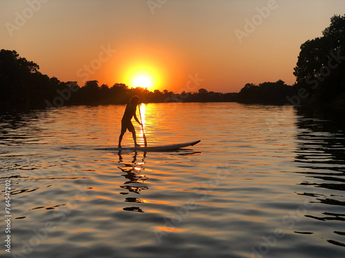 stand up paddle on sunset on a lake © ivu
