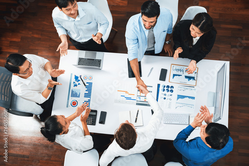 Top view diverse office employee worker shake hand after making agreement on strategic business marketing meeting. Teamwork and positive attitude create productive and supportive workplace. Prudent