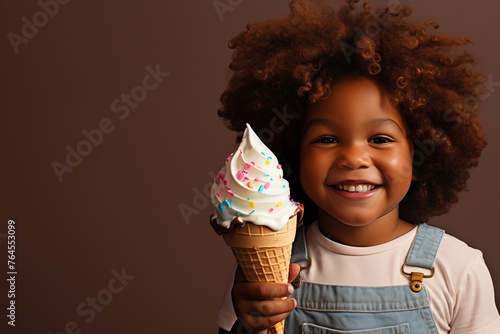 a handsome black boy with afro hair is happy with an ice cream in his hand on a solid brown background photo
