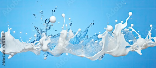 A splash of white milk on a vibrant blue surface creating a beautiful and abstract pattern