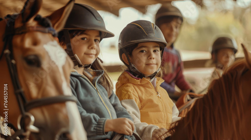 Smiling children in riding helmets enjoy a group equestrian lesson on gentle horses at a sunlit stable