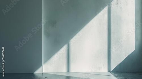 Crisp sunlight filtering through creating a sharp diagonal shadow on a textured white corner wall