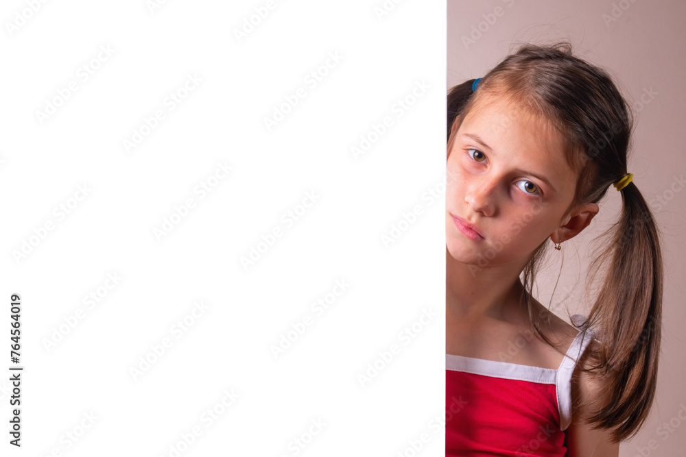 Young girl behind white blank banner or empty copy space advertisement board on brown background, Copy space for text or design. Young girl behind white blank banner or empty copy space advertisement board on brown background, Copy space for text or design.