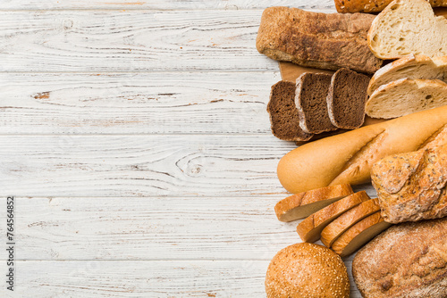 Homemade natural breads. Different kinds of fresh bread as background, top view with copy space