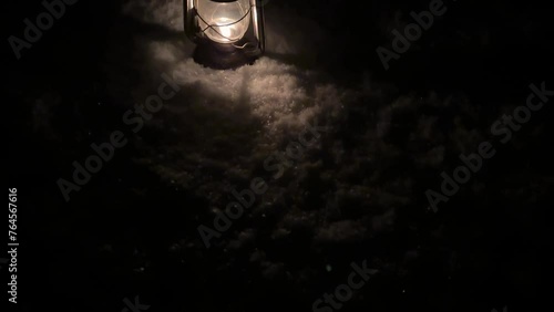 Old antique oil lantern retro kerosene lamp oil in snow in backyard the vintage copper oil lamp in winter season light fire flame burning fuel to light in darkness in rural life Iran local people town photo