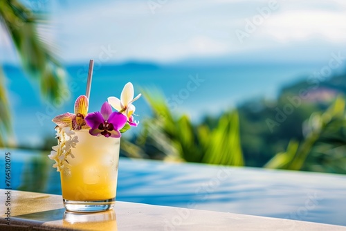 tropical drink with an orchid, infinity pool view