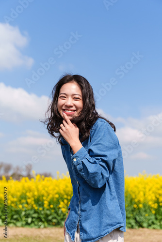 happy young asian woman smile at camera in the sunny spring day