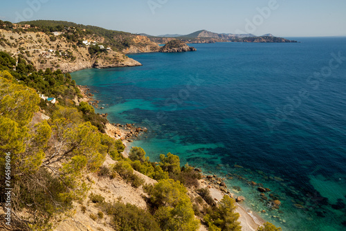Turquoise waters and colorful trees in one of the most reserved and beautiful coves in Ibiza  Cala Llentrisca  Es Cubells  Sant Joan de Sa Talaia  Ibiza  Balearic Islands  Spain