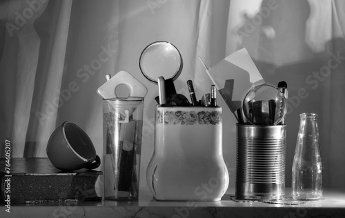 office supplies a book and a coffee cup in a row black and white shot. Home office, work,concept