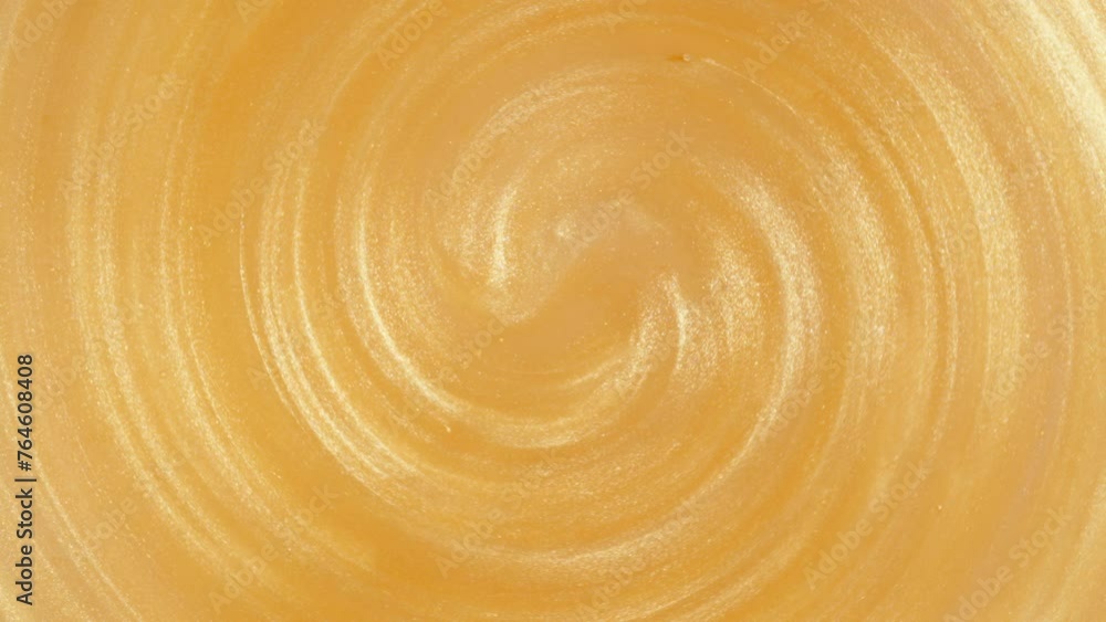 Golden Glitter Particles Spin in the Whirlpool. Macro. Golden Glitter Particles Spin in the Whirlpool. Macro.