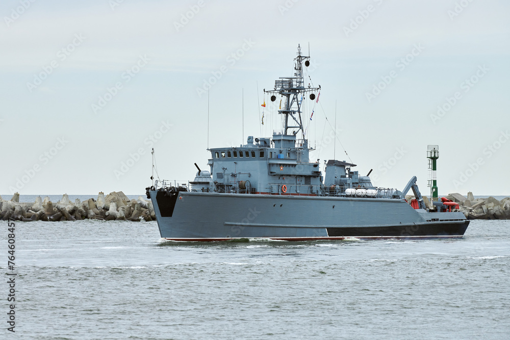 Russian warship armed with armament sails into sea toward military target to attack and destroy enemy, military ship performing strategic maneuver, Russian sea power deployment for tactical advantage