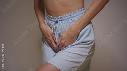 A young woman experiences menstrual pain.