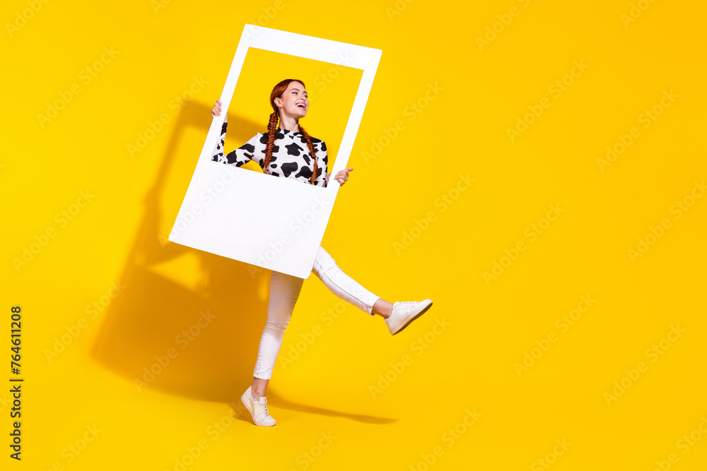 Full length portrait of charming overjoyed person hold set album card dance empty space ad isolated on yellow color background - obrazy, fototapety, plakaty 
