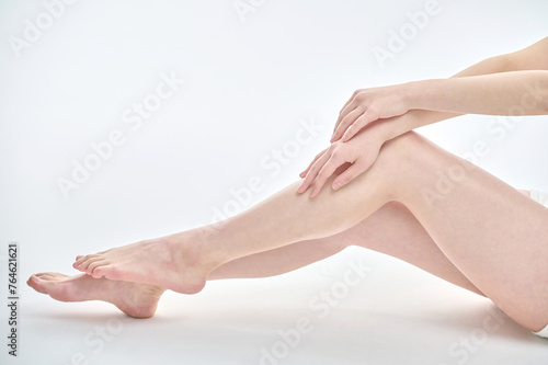 Isolated on the legs, hands and white background of a young Asian woman on a diet.