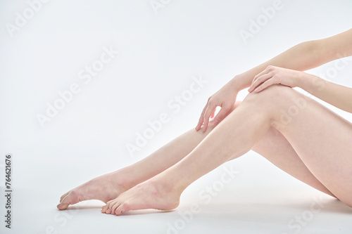 Isolated on the legs, hands and white background of a young Asian woman on a diet.