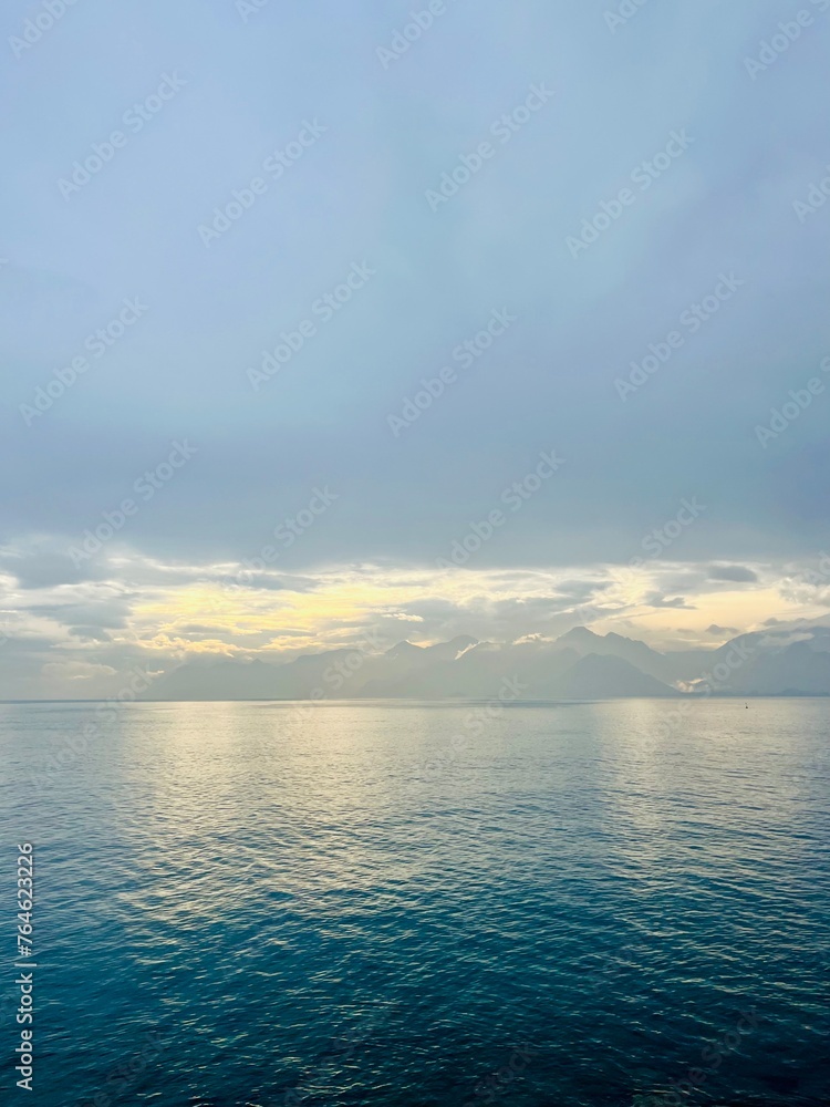 Fantastic seascape background, bright cloudy sky reflection on the blue sea surface, blue sea horizon background Fantastic seascape background, bright cloudy sky reflection on the blue sea surface, blue sea horizon background
