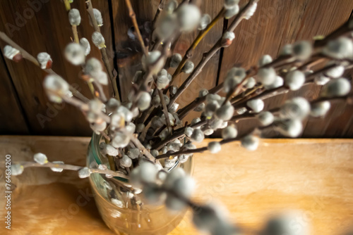 Soft willow buds on wooden background. Spring bouquets are willow branches. Willow branches with soft buds on a wooden table.