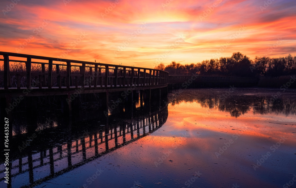 Serene sunset over a tranquil wooden boardwalk, Ciudad Real, Spain Serene sunset over a tranquil wooden boardwalk, Ciudad Real, Spain