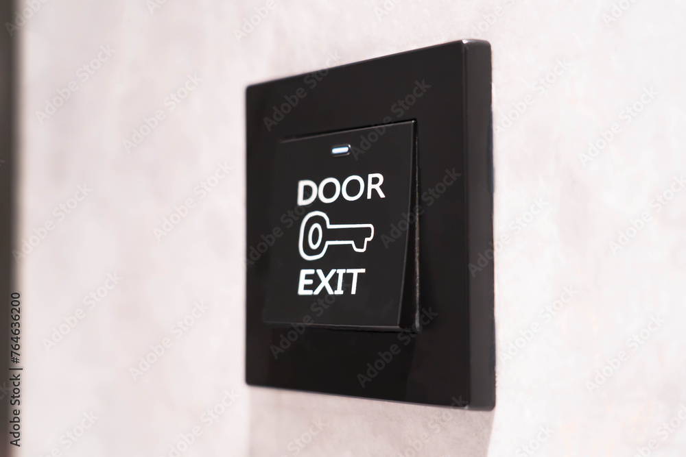 exit door push button on the background of a white wall