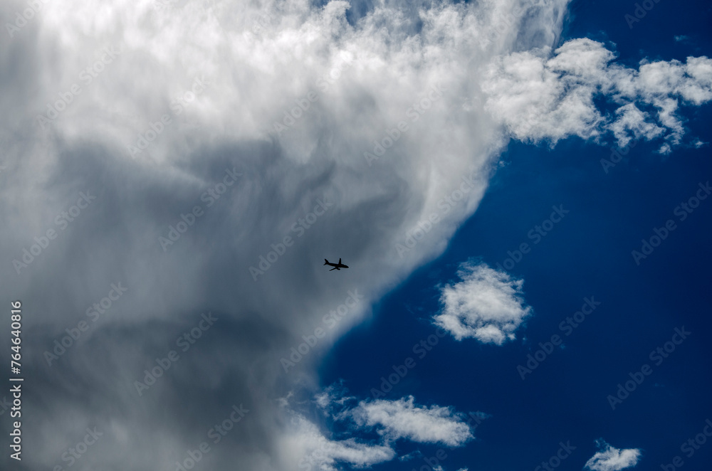 Airplane in the blue sky with white clouds. Cloudscape Airplane in the blue sky with white clouds. Cloudscape