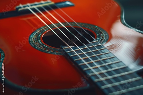 Close up of red guitar with black fretboard
