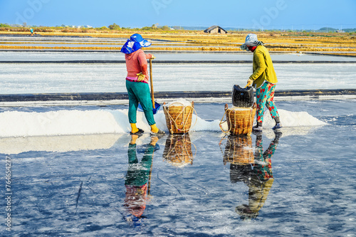 Women are harvesting salt in Can Gio district, a suburban district of Ho Chi Minh City, Vietnam.