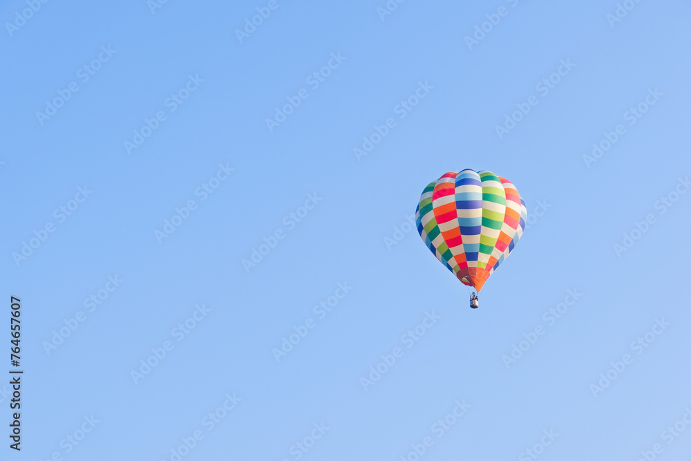 Hot air balloons landing in a mountain flight over field and forest,colorful Hot air balloons flying over the valley with blue sky,Tourism concept. Hot air balloons landing in a mountain flight over field and forest,colorful Hot air balloons flying over the valley with blue sky,Tourism concept.