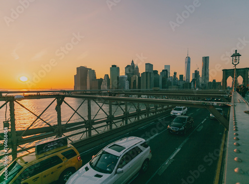beautiful sunset over manhattan with manhattan and brooklyn bridge. Brooklyn Bridge illuminate at night with skyscrapers behind